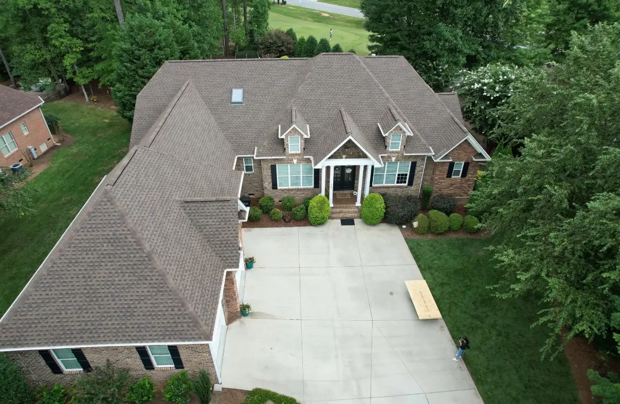 Professional new roof installation featuring Class 4 impact-resistant shingles, premium synthetic underlayment, and a high-flow ridge vent system for 2026 energy efficiency.